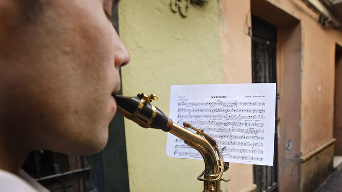 Un músico de la Banda de Música Maestro Dueñas interpreta la marcha 'Ecce Homo' de Eduardo Escobar que aparece en la partitura.
