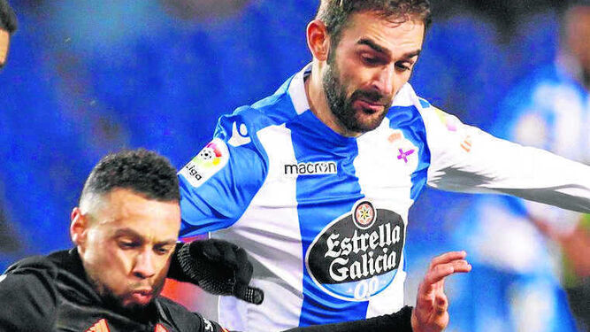 El deportivista Adrián López le pelea el balón a Rubén Vezo.