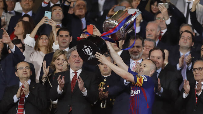 Iniesta levanta la Copa del Rey en el palco de autoridades.