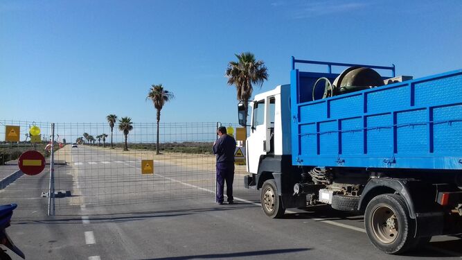 Un camión de obra, ayer, se dispone a acceder a la playa de Camposoto, cuya carretera lleva semanas cortada por las obras de la Junta para la pasarela.