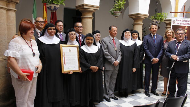 Las religiosas con miembros de la Corporación municipal tras la entrega del reconocimiento.