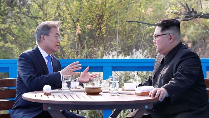 Kim Jong-un (d) y Moon Jae-in (i) conversan en la zona desmilitarizada durante la cumbre intercoreana en Panmunjom.