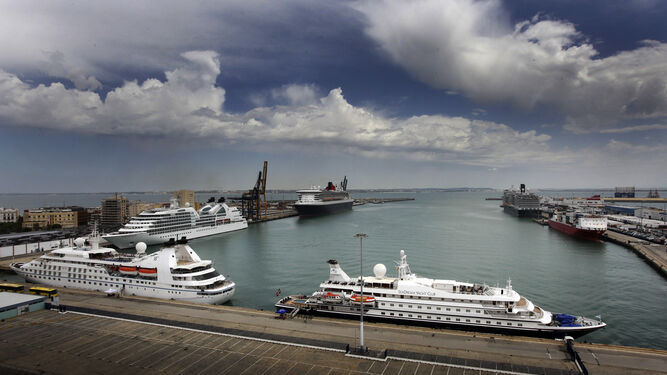 El 'Queen Mary 2', con su peculiar casco negro, quedó amarrado ayer junto a la actual terminal de contenedores del puerto de Cádiz.