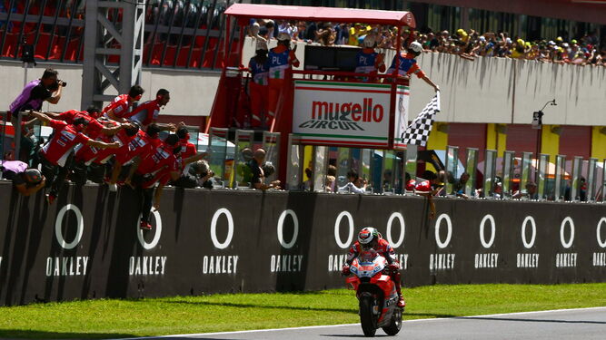 Jorge Lorenzo, aclamado por los mecánicos de su equipo, cruza en solitario la línea de meta y se proclama ganador del Gran Premio de Italia.