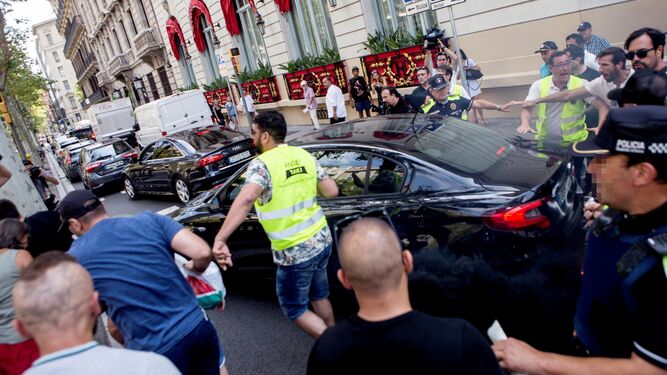 Taxistas increpan a un vehículo frente al Hotel Palace durante la manifestación.