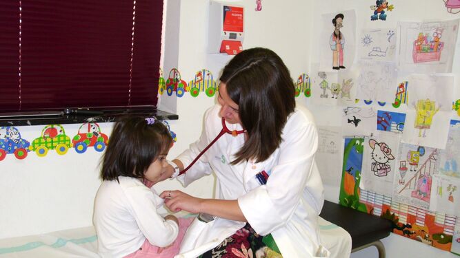 Una pediatra atendiendo a una niña en un centro de salud.
