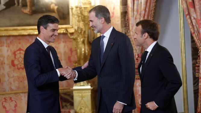 Pedro Sánchez saluda al Rey el pasado 26 de julio en el Palacio Real en presencia de Emmanuel Macron.
