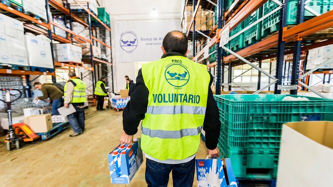 Voluntario del Banco de Alimentos con cajas de leche.