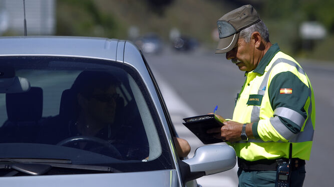 Un Guardia Civil anota una infracción para remitírsela a un conductor
