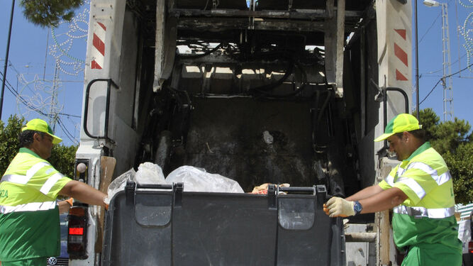 Dos operarios de recogida de basura con un camión en el recinto ferial, en una imagen de archivo.