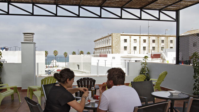 Clientes de un apartamento de Cádiz desayunan en la terraza.