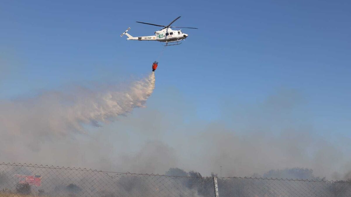 Un helicóptero descarga agua sobre la zona afectada.