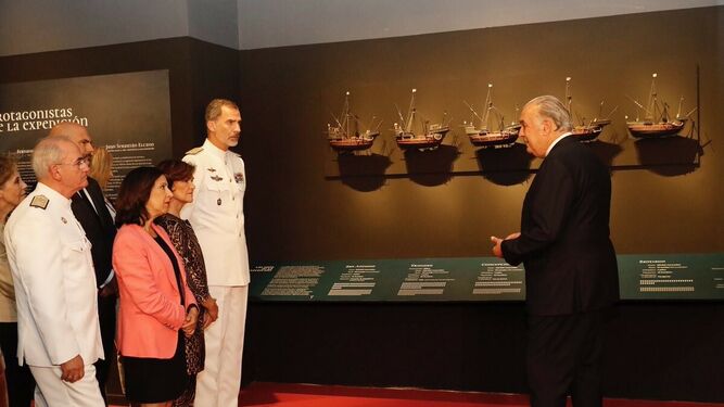 El Rey, junto a las ministras Carmen Calvo y Margarita Robles, observa una de las piezas de la exposición.