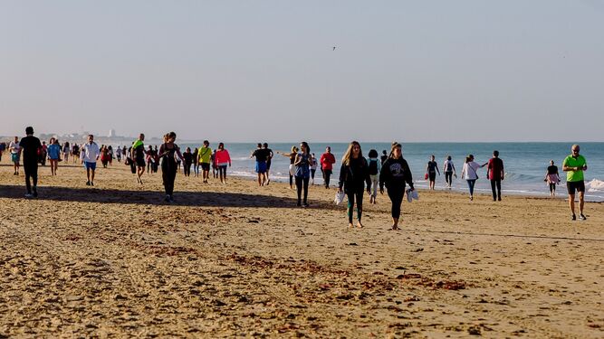 Decenas de personas pasean por la playa de Cádiz en la mañana del pasado sábado.