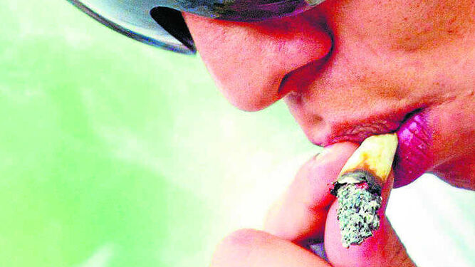 Un joven fumando un cigarrillo de cannabis.