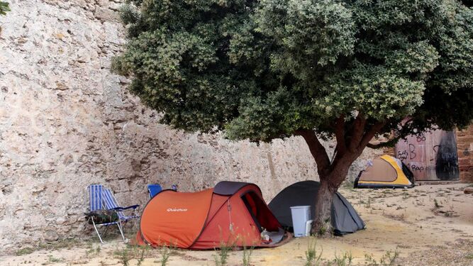 Personas sin hogar acampadas en el foso de las Puertas de Tierra.