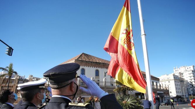 Izado de la bandera española en el mástil de la plaza de Sevilla.