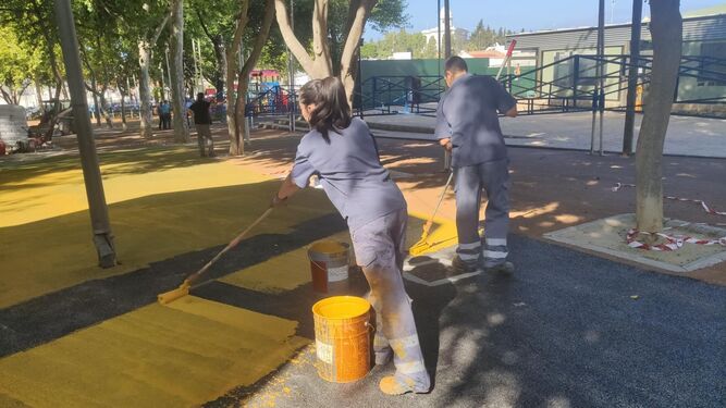 Trabajadores del plan de empleo juvenil pintan la superficie del Parque Almirante Laulhé para la Feria.