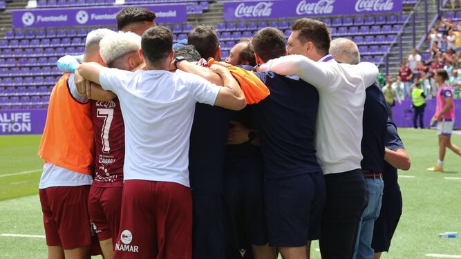 Jugadores y técnicos del Sanluqueño se abrazan tras ganar en Valladolid.